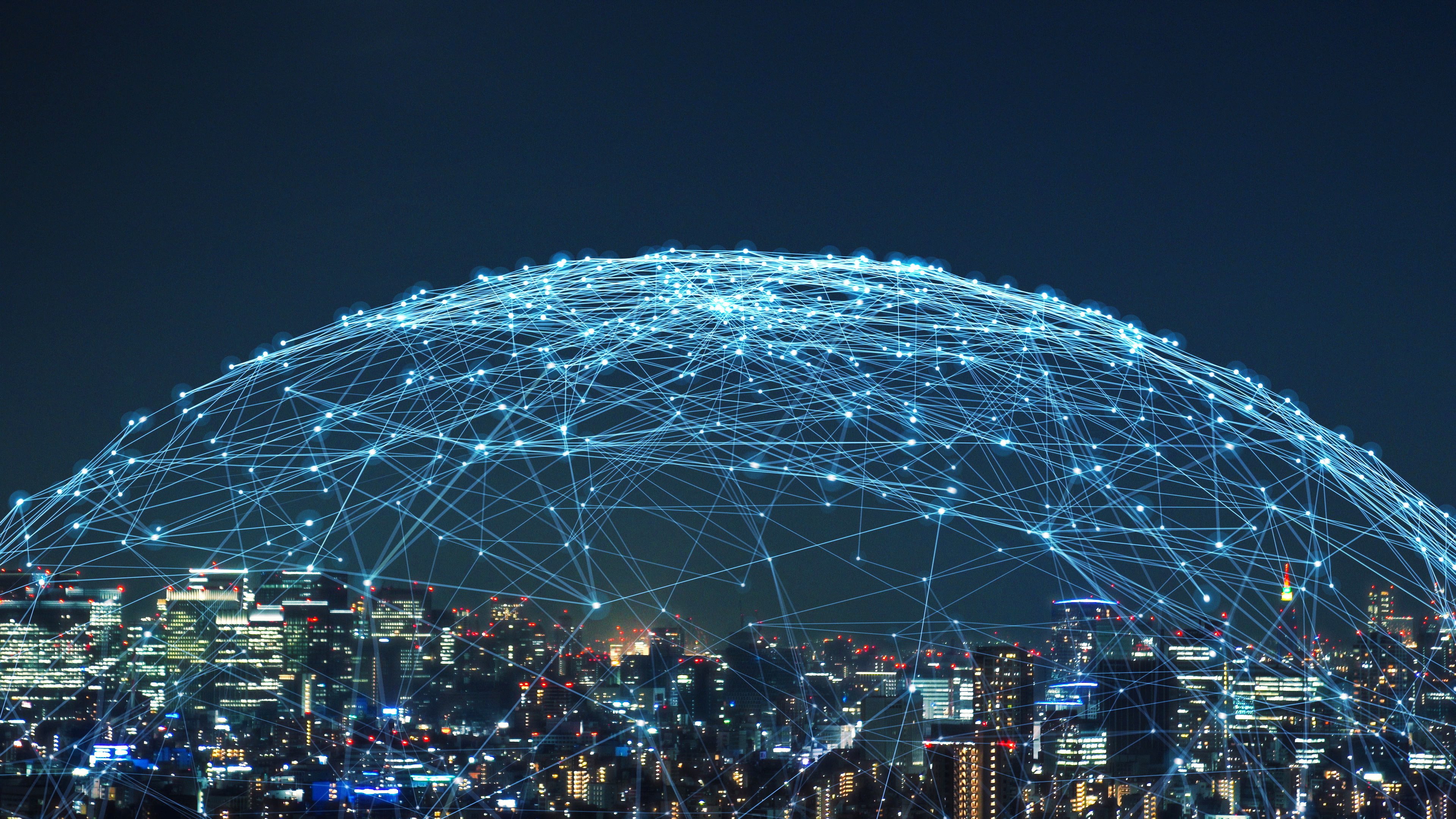 A cityscape at night covered by a dome of interconnected lights, representing on-net connectivity
